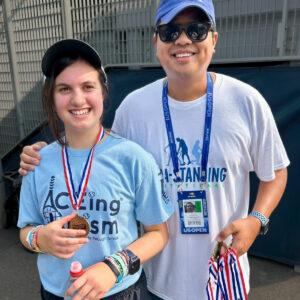 ACEing Autism athlete Maddie LoPiccolo smiling at a clinic at the US Open