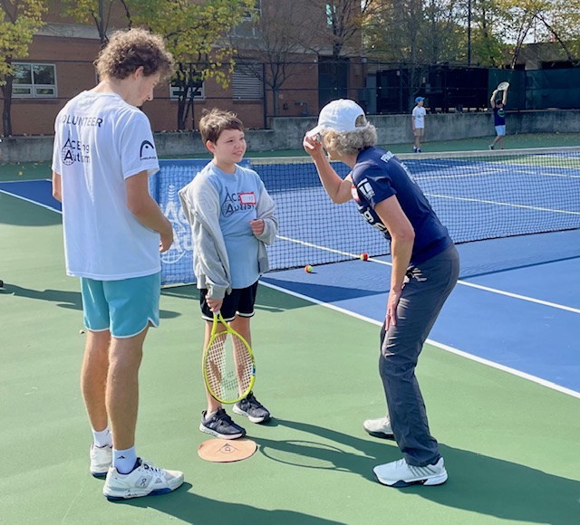 ACEing Autism athlete Eli with volunteers